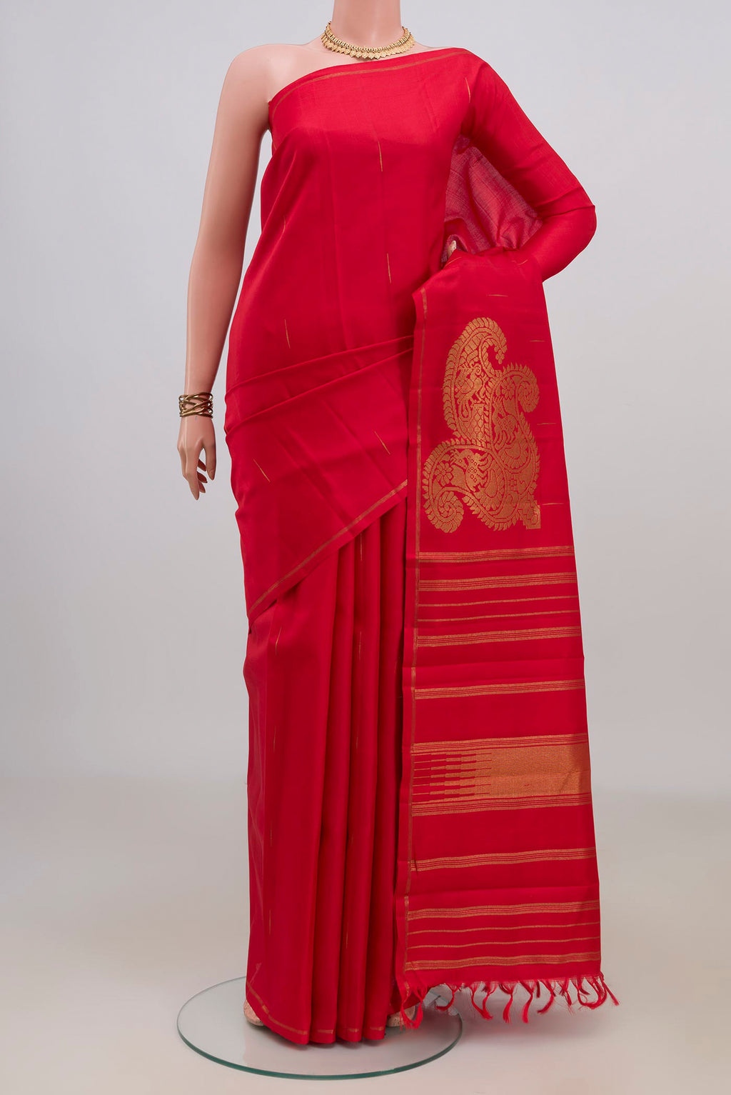 Pure Silk Pure Zari Red Kanjivaram Saree with Zari Butta on the body and Thin Zari Line.  displayed on a mannequin