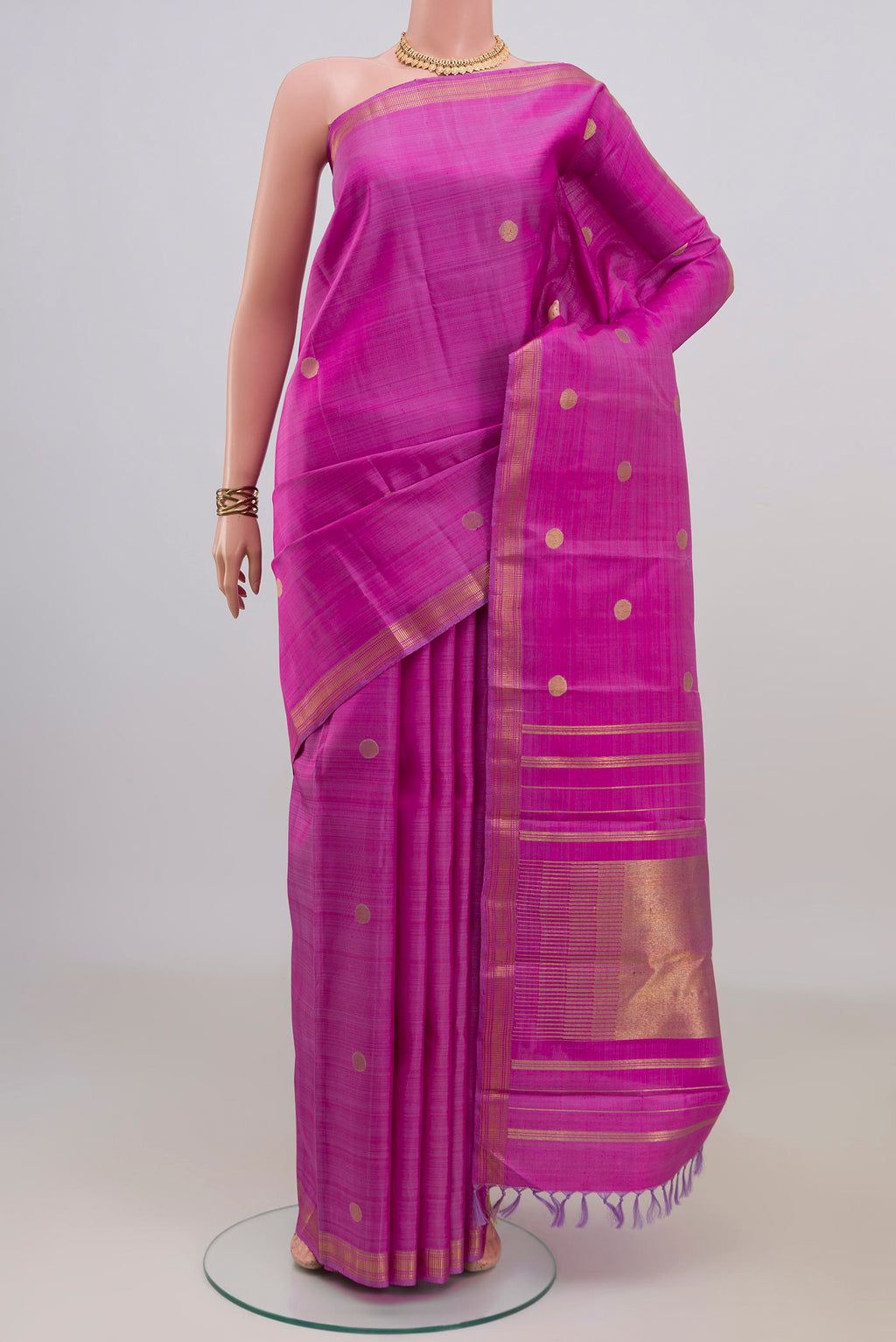 Pure Silk Pure Zari Magenta Kanchipuram Saree with Zari Butta on the body and Zari Border.  displayed on a mannequin