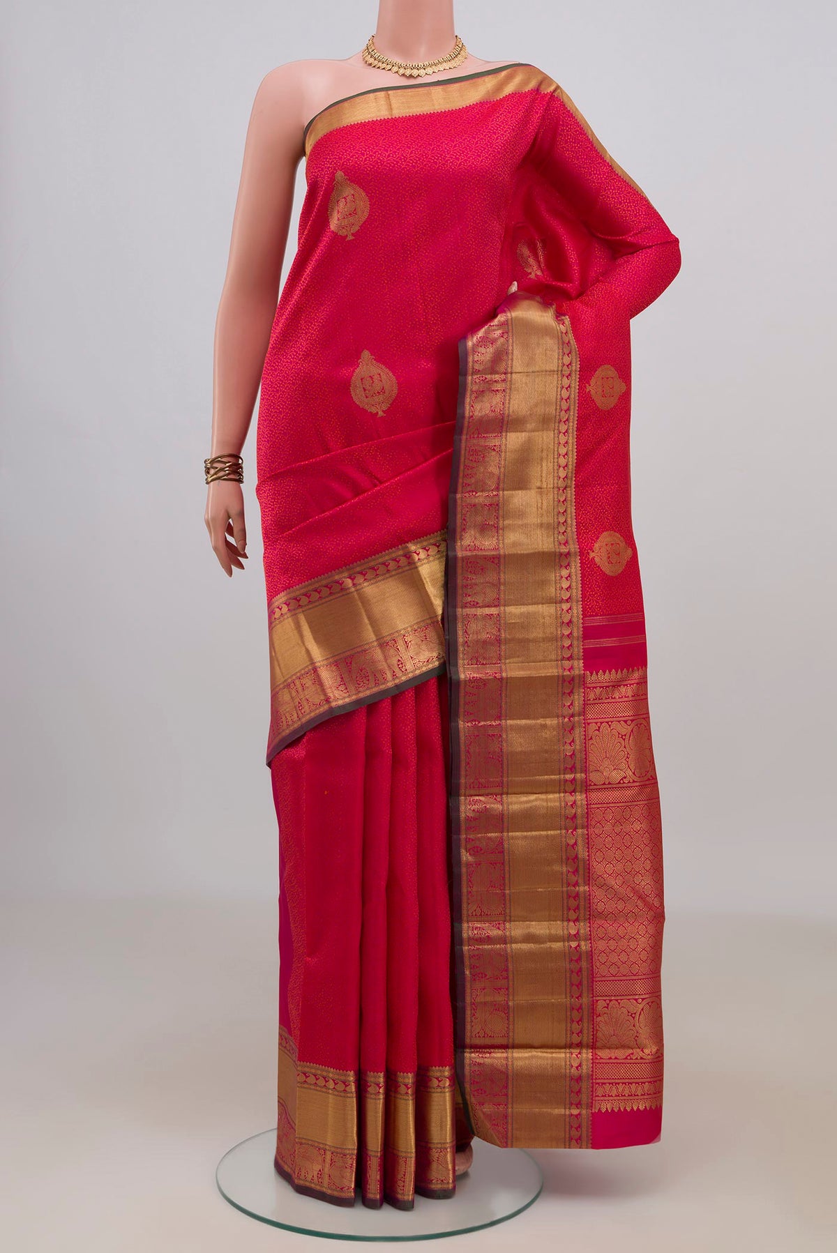 Pure Silk Pure Zari Pink Kanjivaram Saree with Jacquard With Zari Butta on the body and Zari Border.  displayed on a mannequin
