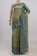 Gold with Blue Color Kanchipuram Tissue Saree with Zari Brocade on the body and Fancy Border.  displayed on a mannequin