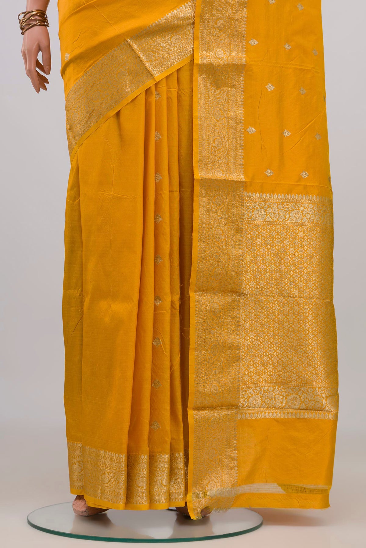 Pleats and pallu of Yellow Banarasi Katan Silk Saree with Zari Butta on the body and Zari Border. 