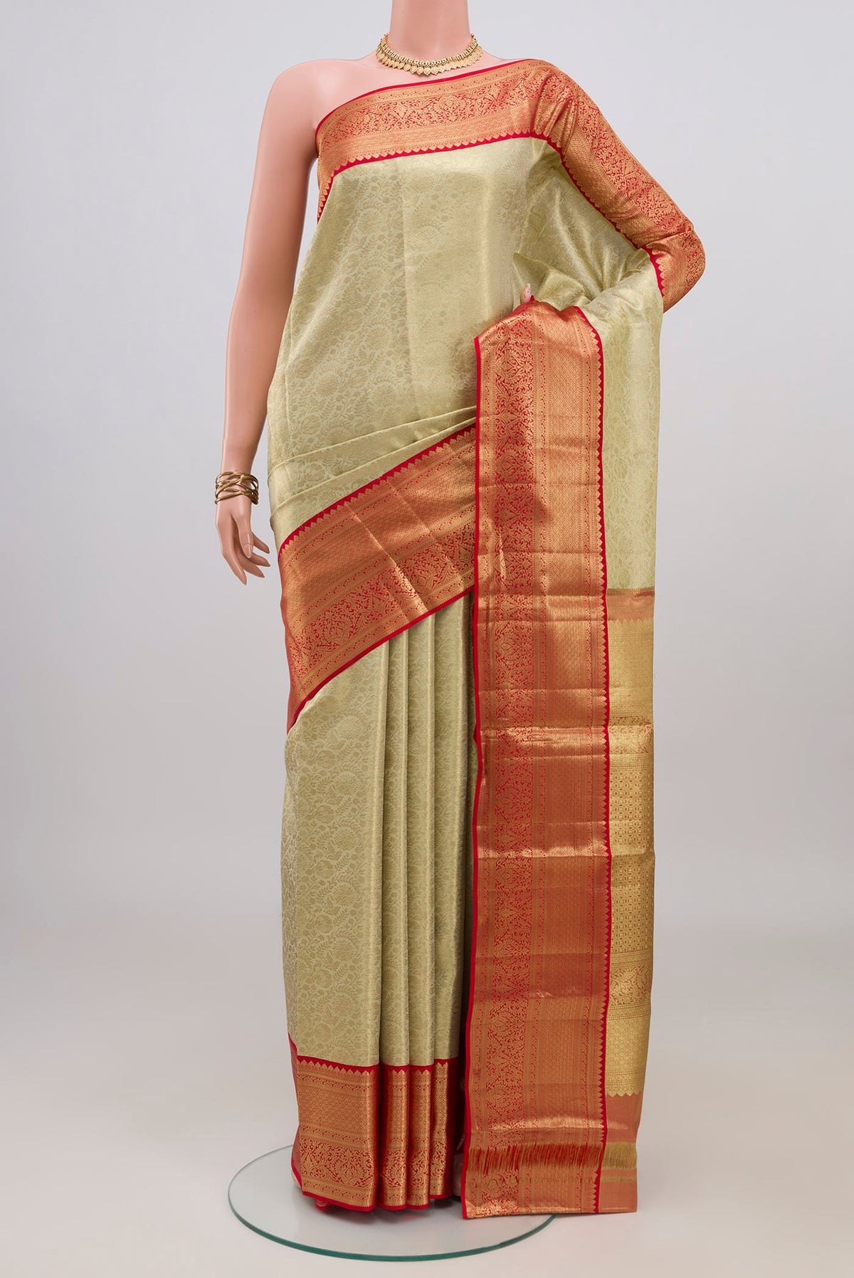 Cream Kanjivaram Tissue Silk Saree with Zari Brocade on the body and Zari Border.  displayed on a mannequin