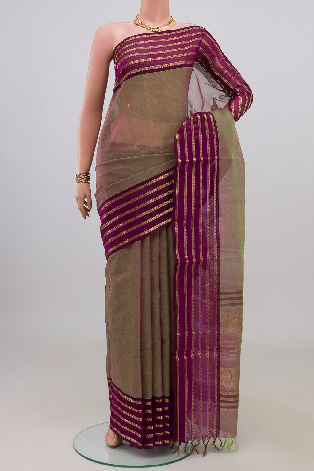 Green Dual Tone Silk Cotton Saree with Zari Butta on the body and Zari Border.  displayed on a mannequin