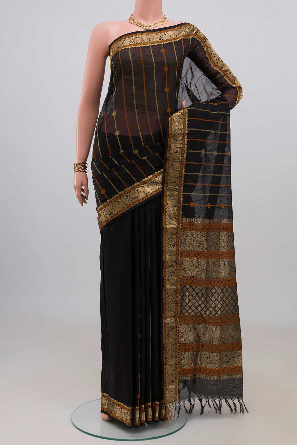 Black Silk Cotton Saree with Stripes on the body and Zari Border.  displayed on a mannequin