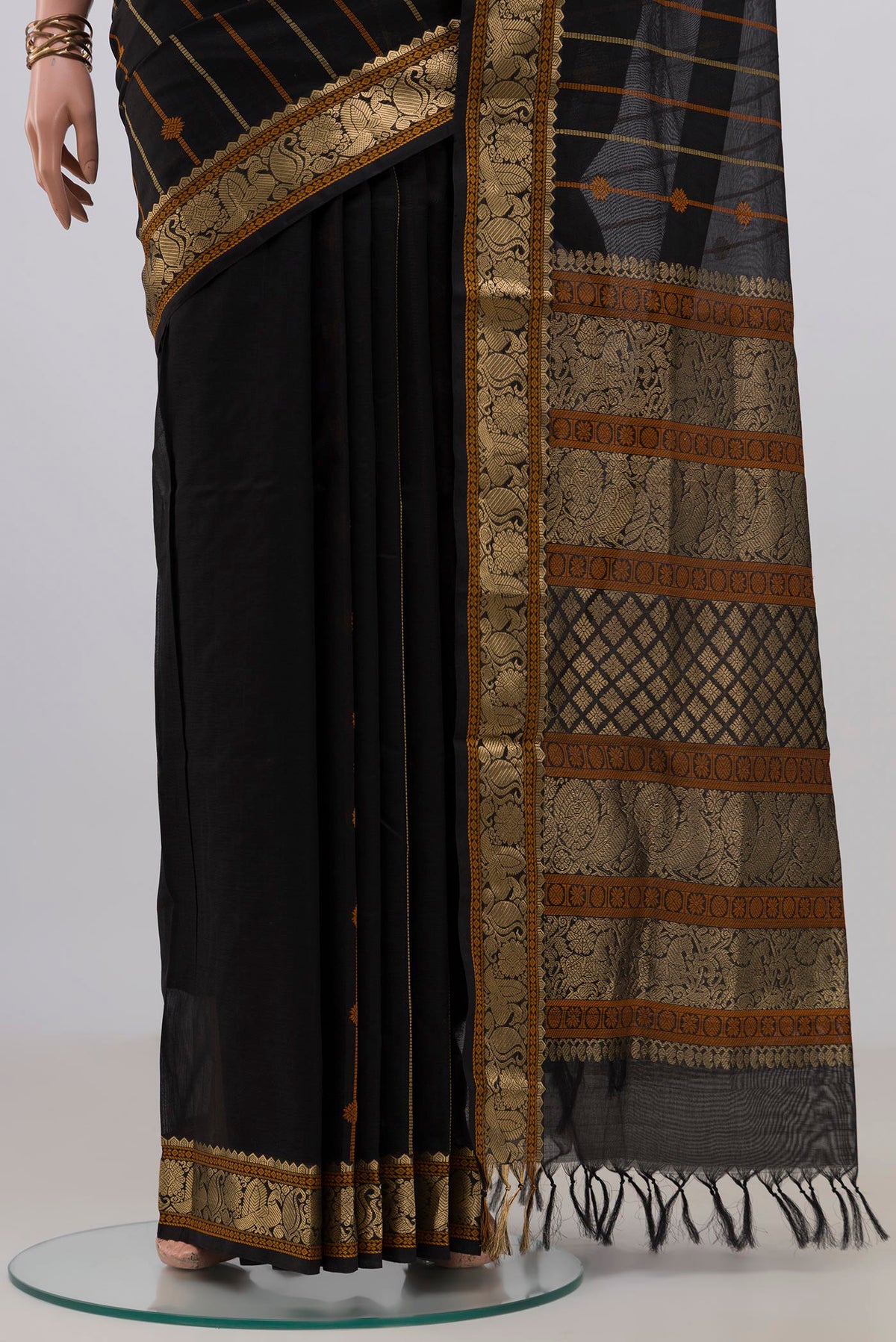 Pleats and pallu of Black Silk Cotton Saree with Stripes on the body and Zari Border. 