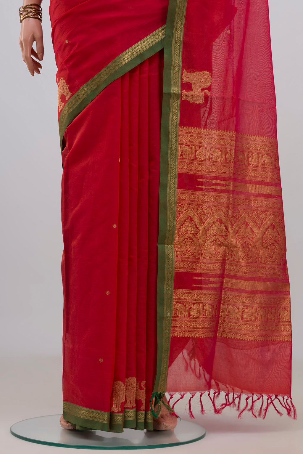 Pleats and pallu of Orange Silk Cotton Saree with Zari Butta on the body and Zari Border. 