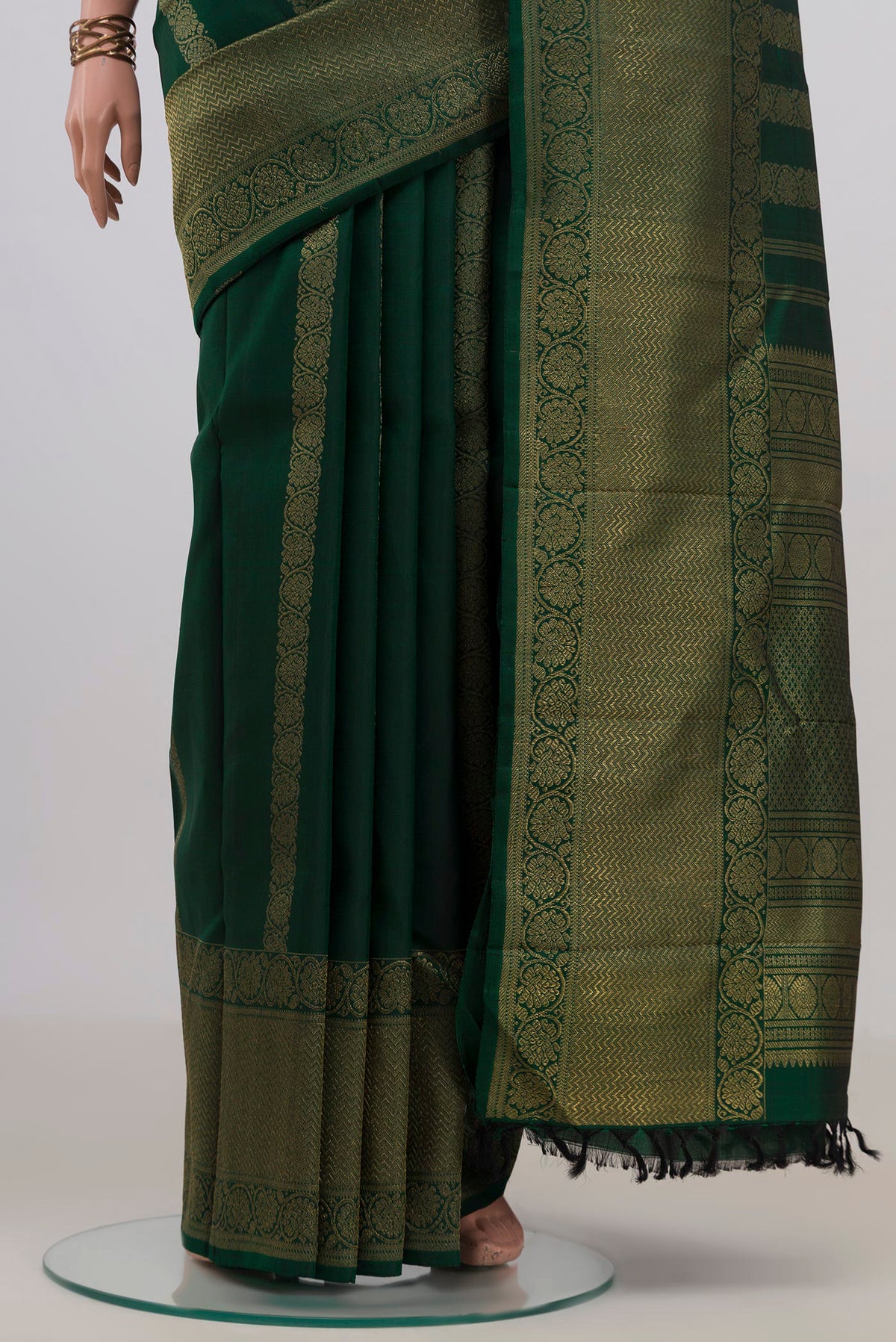 Pleats and pallu of Pure Silk Pure Zari Bottle Green Kanjivaram Saree with Stripes on the body and Zari Border. 