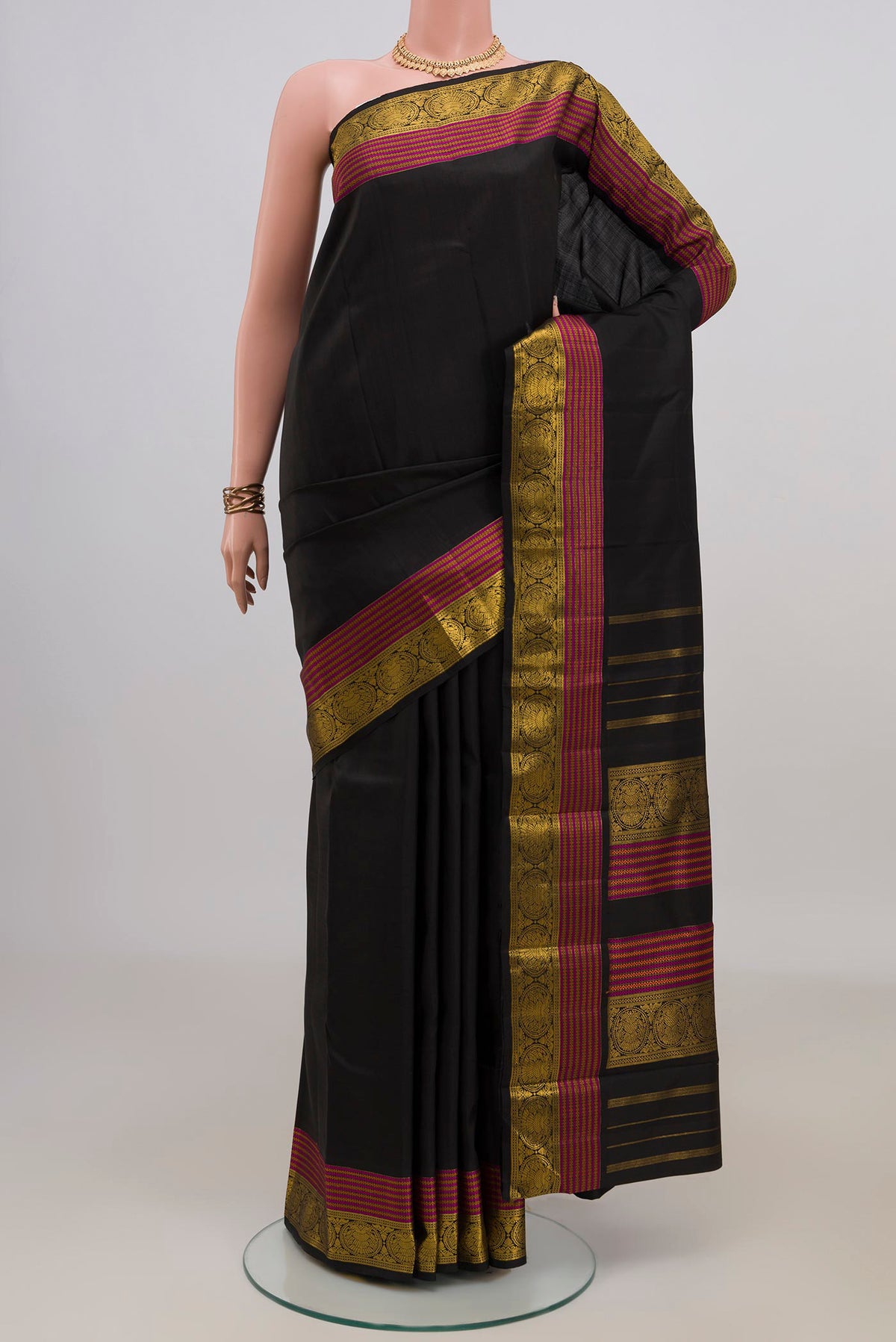 Pure Silk Black Kanchipuram Saree with Plain Body and Zari Border.  displayed on a mannequin