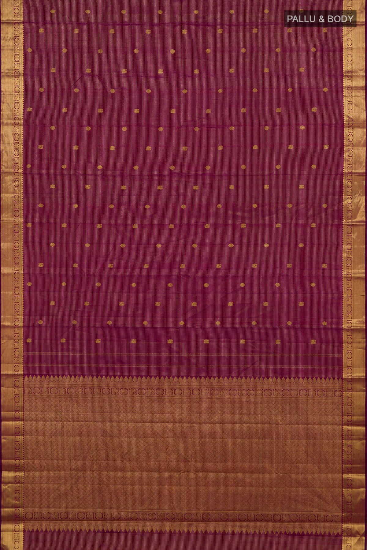 Flat view of Magenta Kanchipuram Silk Saree with Zari Butta on the body and Zari Border. 