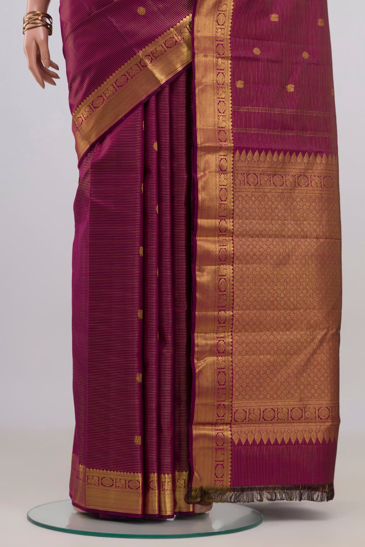 Pleats and pallu of Magenta Kanchipuram Silk Saree with Zari Butta on the body and Zari Border. 