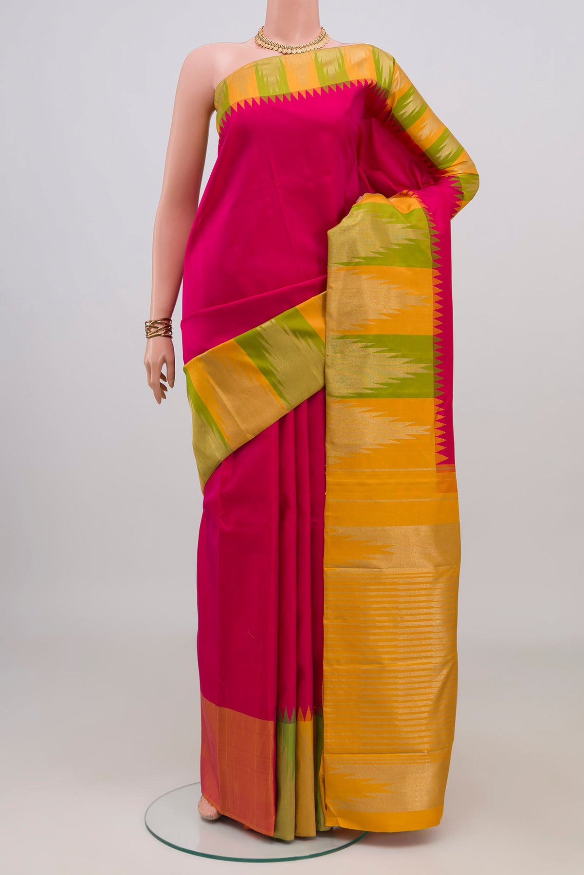 Pure Silk Pure Zari Pink Kanjivaram Saree with Plain Body and Temple Border.  displayed on a mannequin