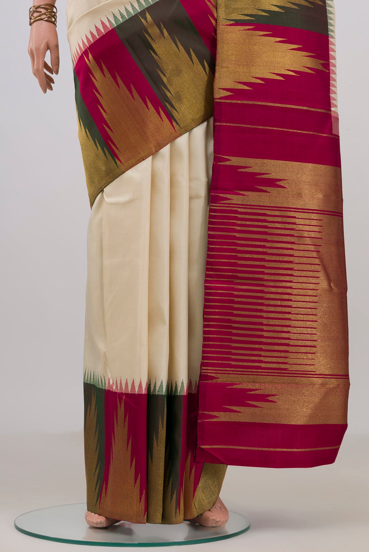 Pleats and pallu of Pure Silk Pure Zari Cream Kanjivaram Saree with Plain Body and Temple Border. 