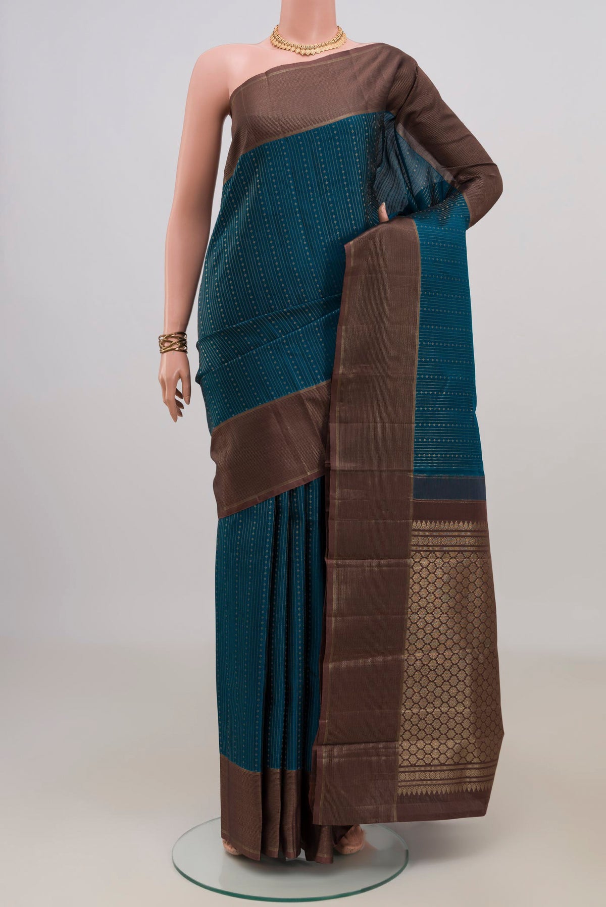 Pure Silk Blue Kanchipuram Saree with Stripes on the body and Zari Border.  displayed on a mannequin
