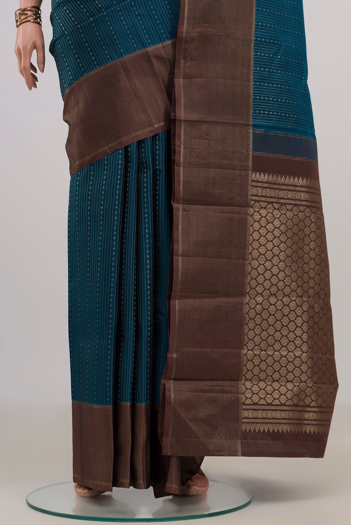 Pleats and pallu of Pure Silk Blue Kanchipuram Saree with Stripes on the body and Zari Border. 