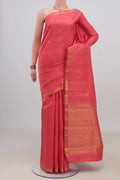 Pure Silk Coral Kanjivaram Saree with Jacquard With Zari Butta on the body and Zari Border.  displayed on a mannequin