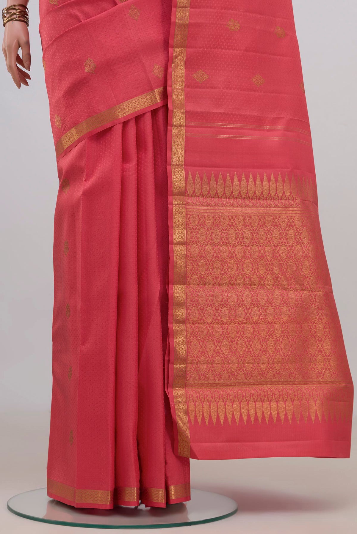 Pleats and pallu of Pure Silk Coral Kanjivaram Saree with Jacquard With Zari Butta on the body and Zari Border. 