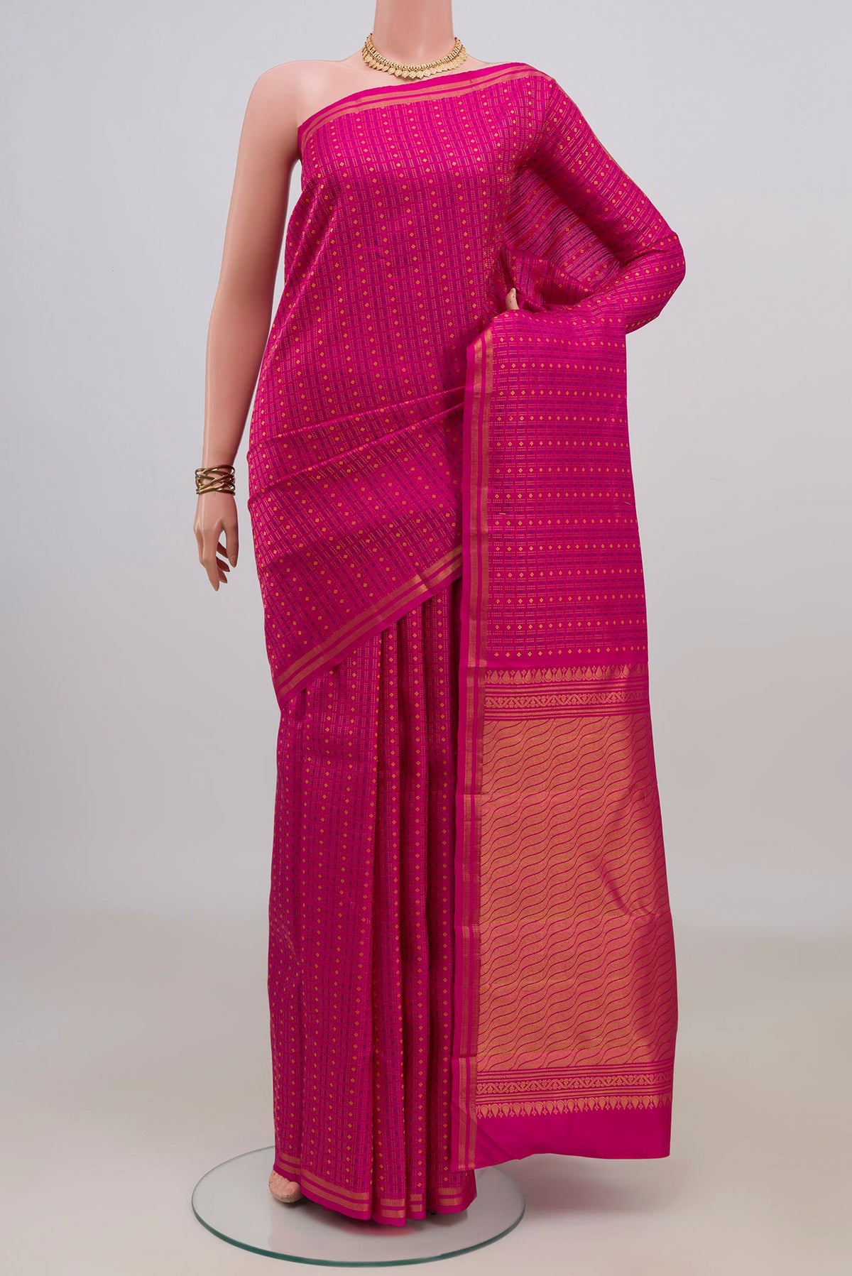 Pure Silk Pink Kanchipuram Saree with Zari And Thread Butta on the body and Thin Zari Line.  displayed on a mannequin