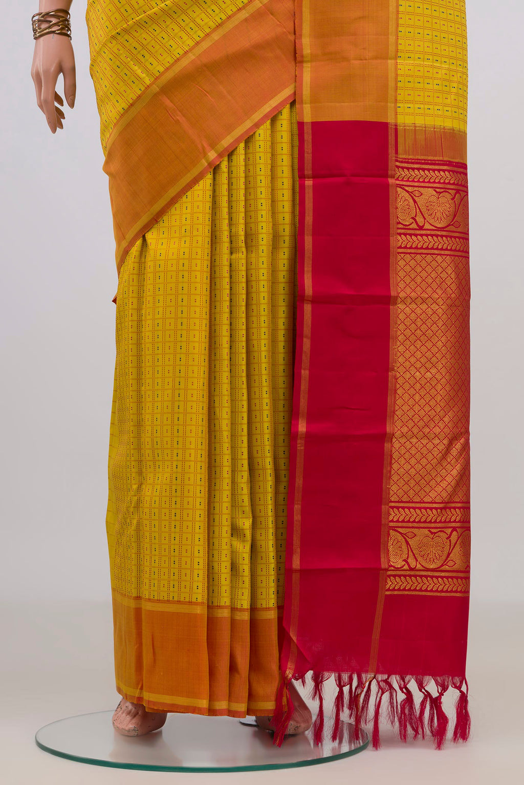 Pleats and pallu of Pure Silk Yellow Kanchipuram Saree with Checked design on the body and Zari Border. 