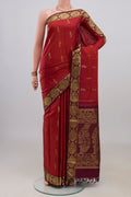 Pure Silk Rust Kanchipuram Saree with Zari Butta on the body and Zari Border.  displayed on a mannequin