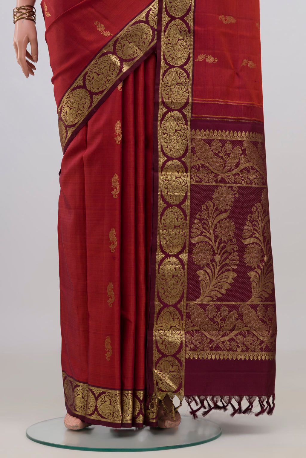 Pleats and pallu of Pure Silk Rust Kanchipuram Saree with Zari Butta on the body and Zari Border. 