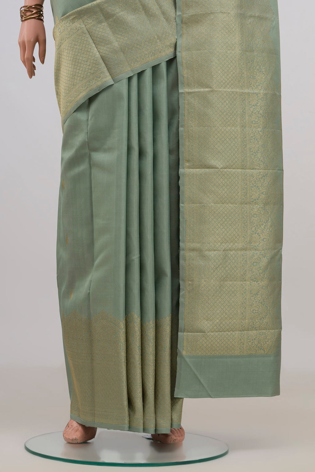 Pleats and pallu of Pure Silk Sage Green Kanjivaram Saree with Zari Butta on the body and Fancy Border. 