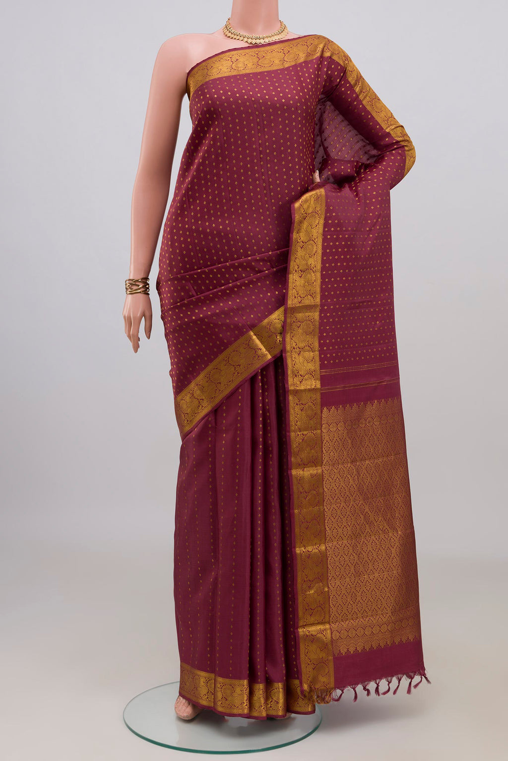 Pure Silk Mauve Kanjivaram Saree with Zari Butta on the body and Zari Border.  displayed on a mannequin