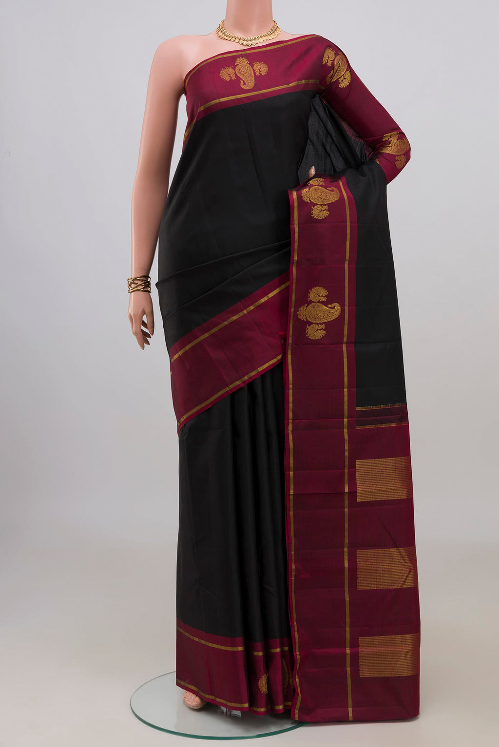 Pure Silk Black Kanchipuram Saree with Plain Body and Fancy Border.  displayed on a mannequin