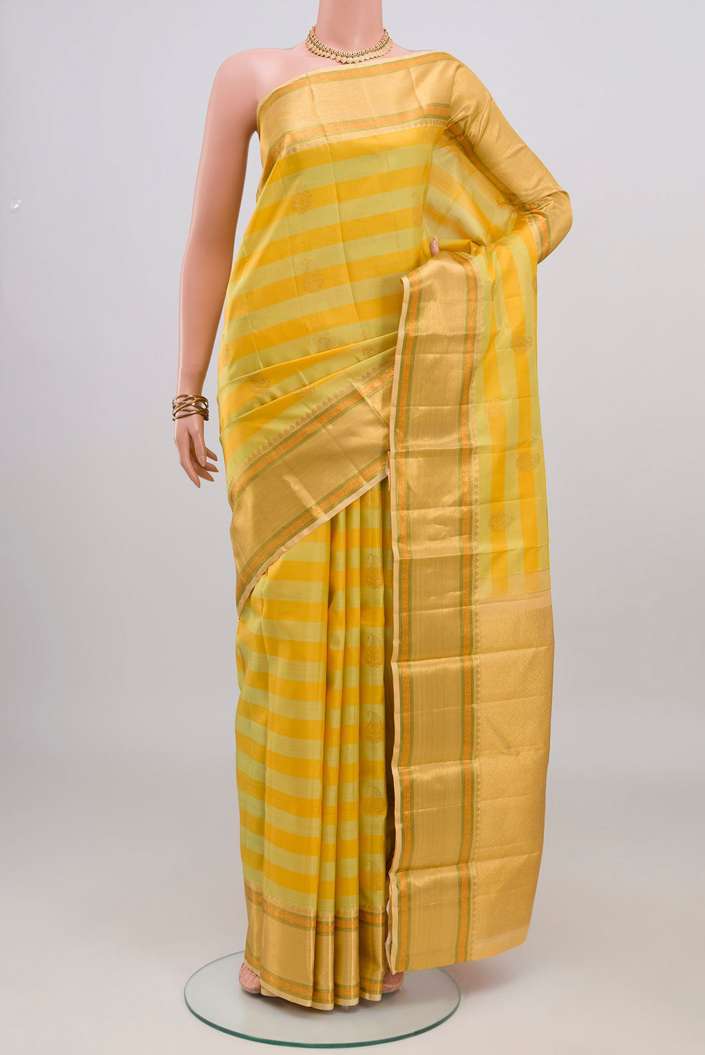 Yellow Kanjivaram Silk Saree with Stripes on the body and Zari Border.  displayed on a mannequin