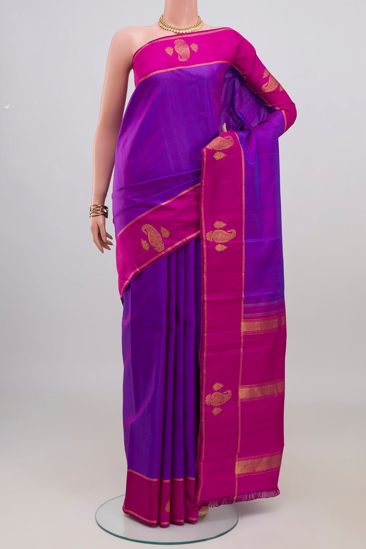 Purple Kanchipuram Silk Saree with Plain Body and Plain Border.  displayed on a mannequin