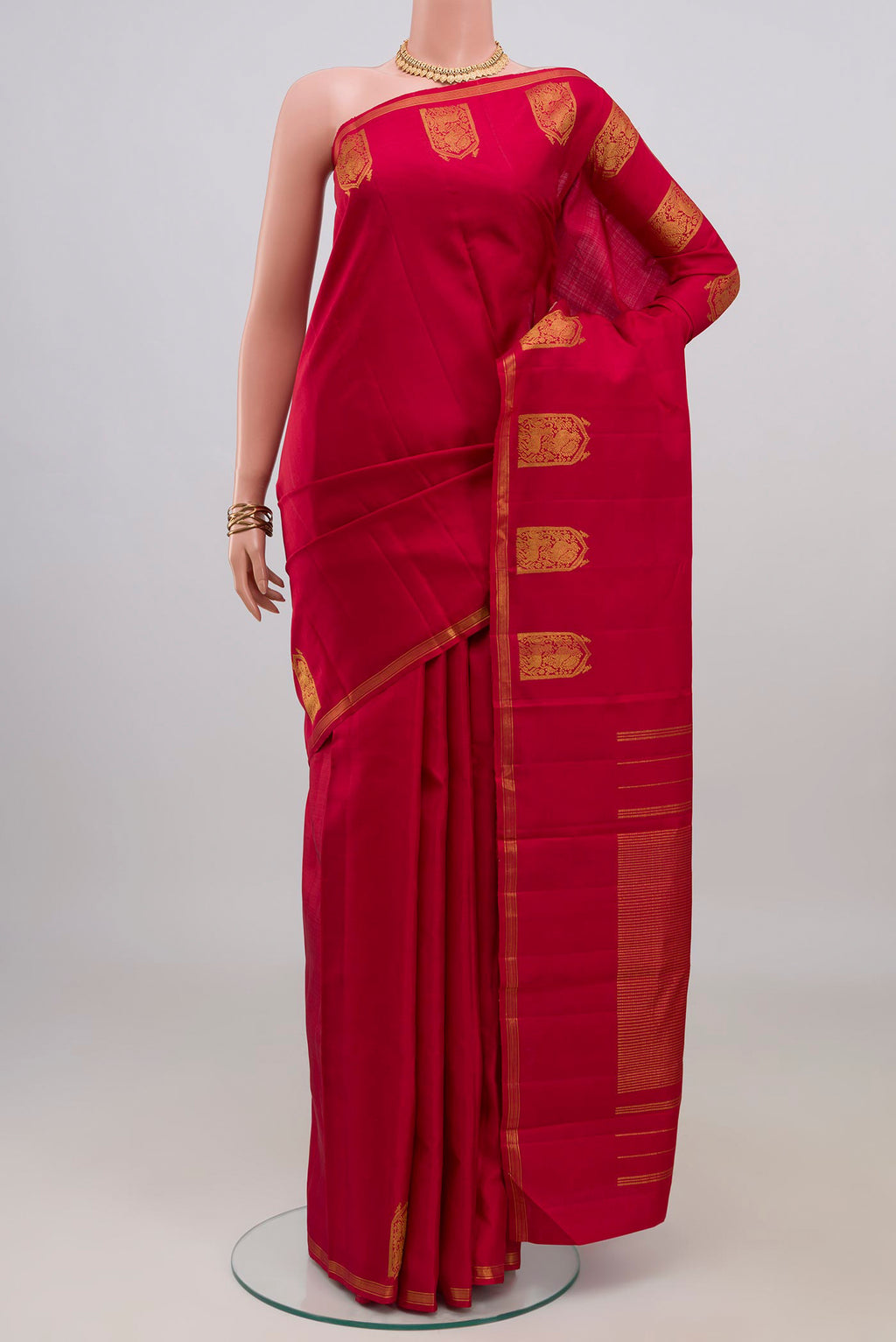 Maroon Kanchipuram Silk Saree with Plain Body and Zari Border.  displayed on a mannequin