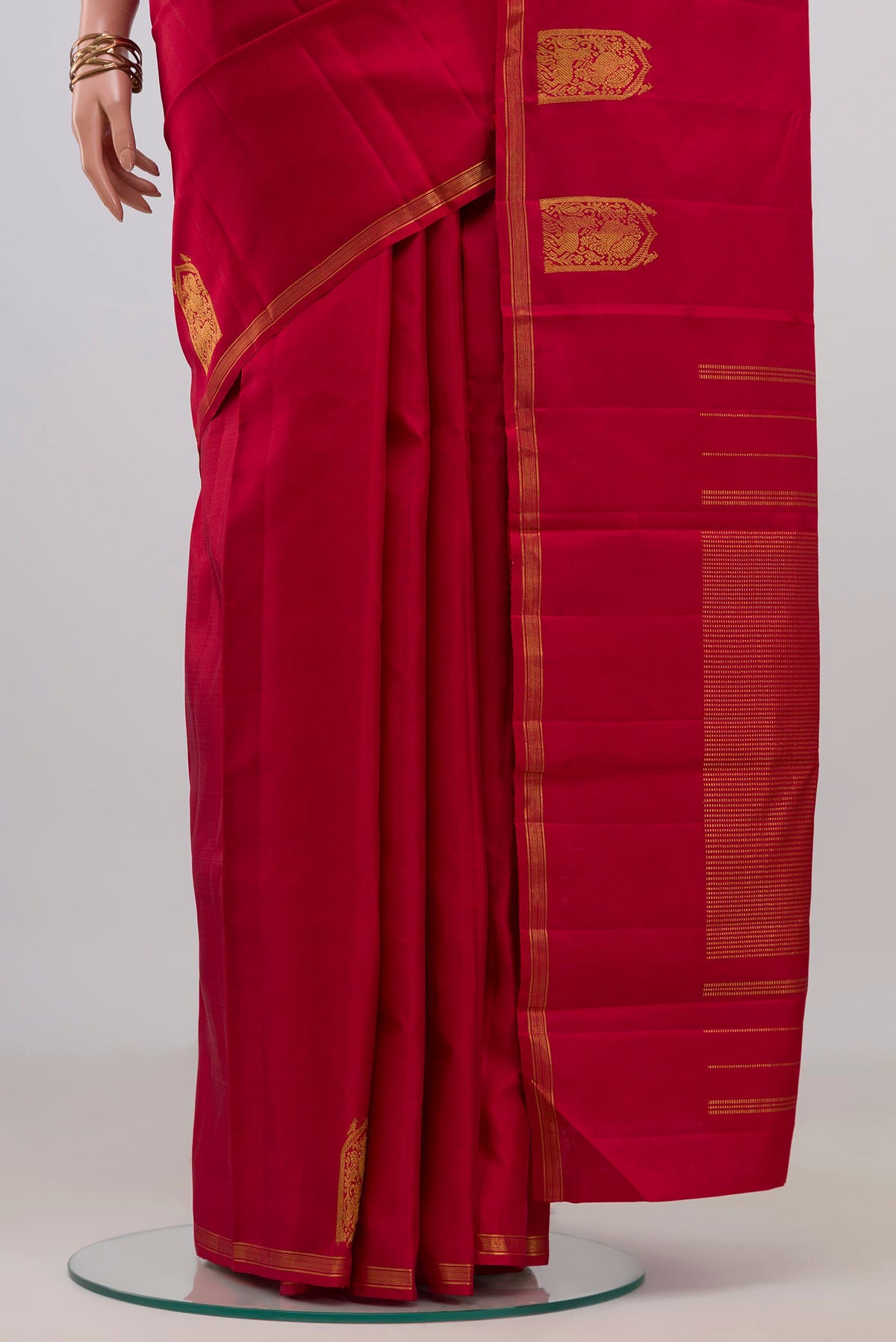 Pleats and pallu of Maroon Kanchipuram Silk Saree with Plain Body and Zari Border. 