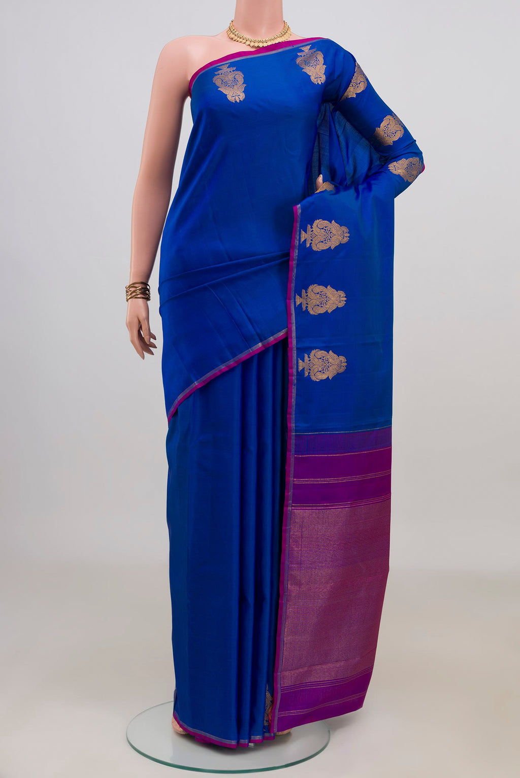 Pure Silk Royal Blue Kanchipuram Saree with Plain Body and Thin Zari Line.  displayed on a mannequin