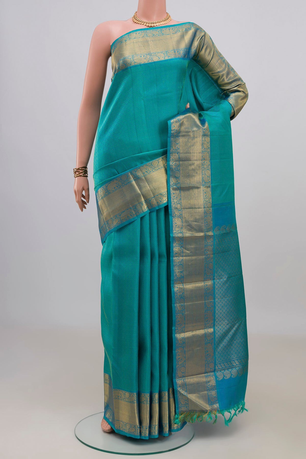 Pure Silk Turquoise Kanjivaram Saree with Jacquard design on the body and Zari Border.  displayed on a mannequin