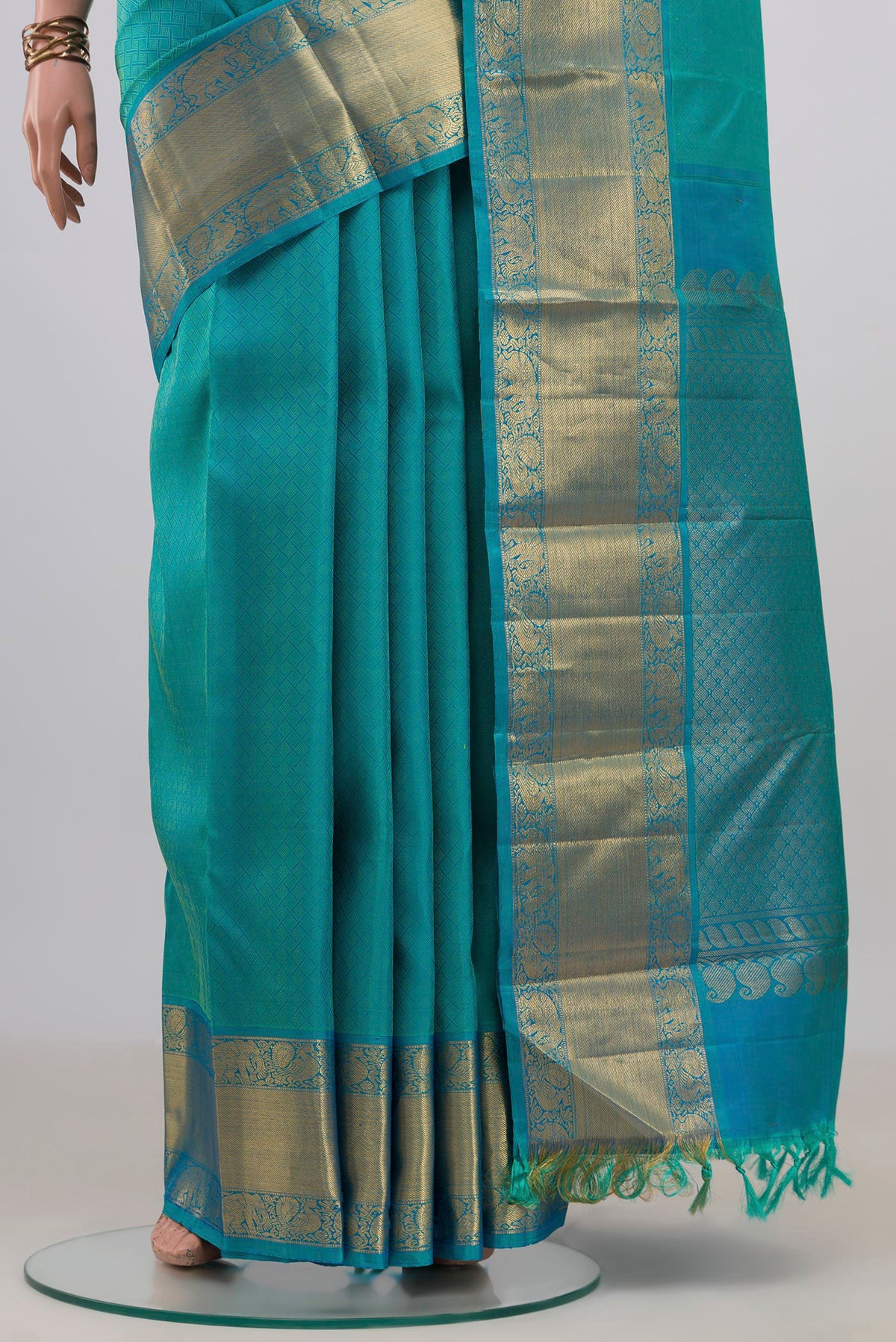 Pleats and pallu of Pure Silk Turquoise Kanjivaram Saree with Jacquard design on the body and Zari Border. 
