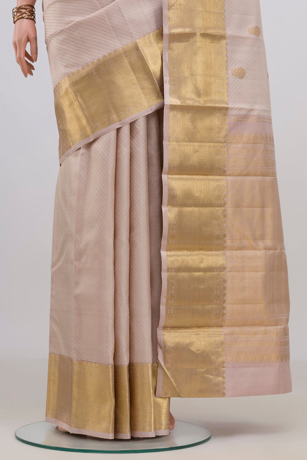 Pleats and pallu of Pure Silk Beige Kanjivaram Saree with Jacquard With Zari Butta on the body and Zari Border. 