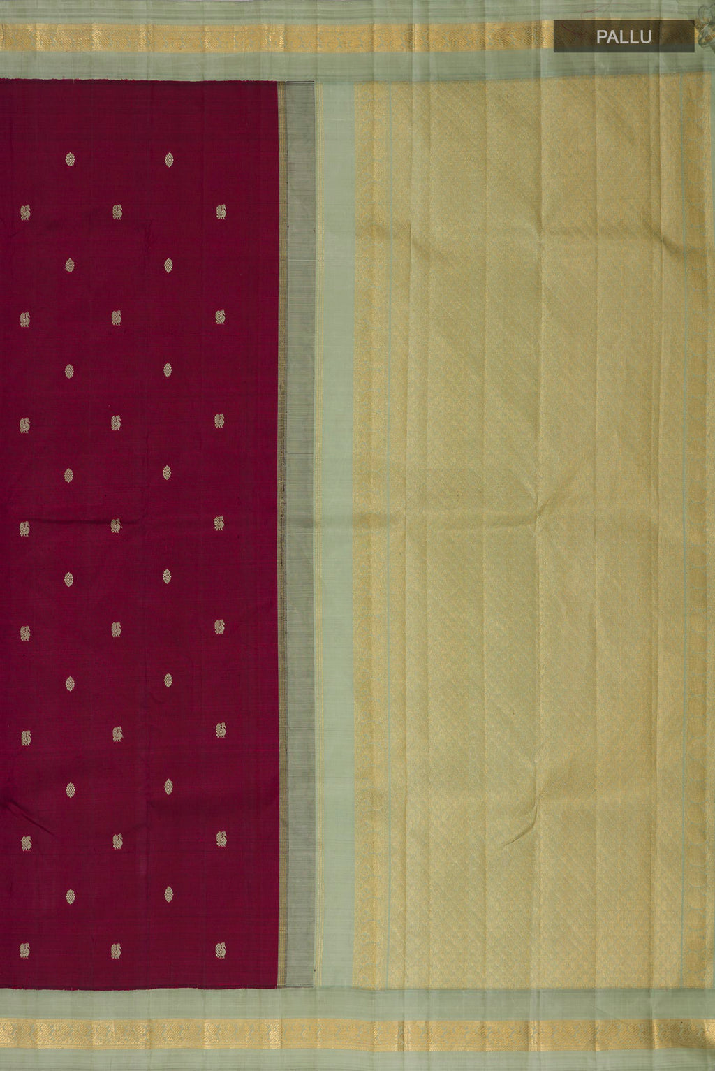 Close up image of the pallu of Pure Silk Maroon Kanjivaram Saree with Thread Butta on the body and Zari Border. 