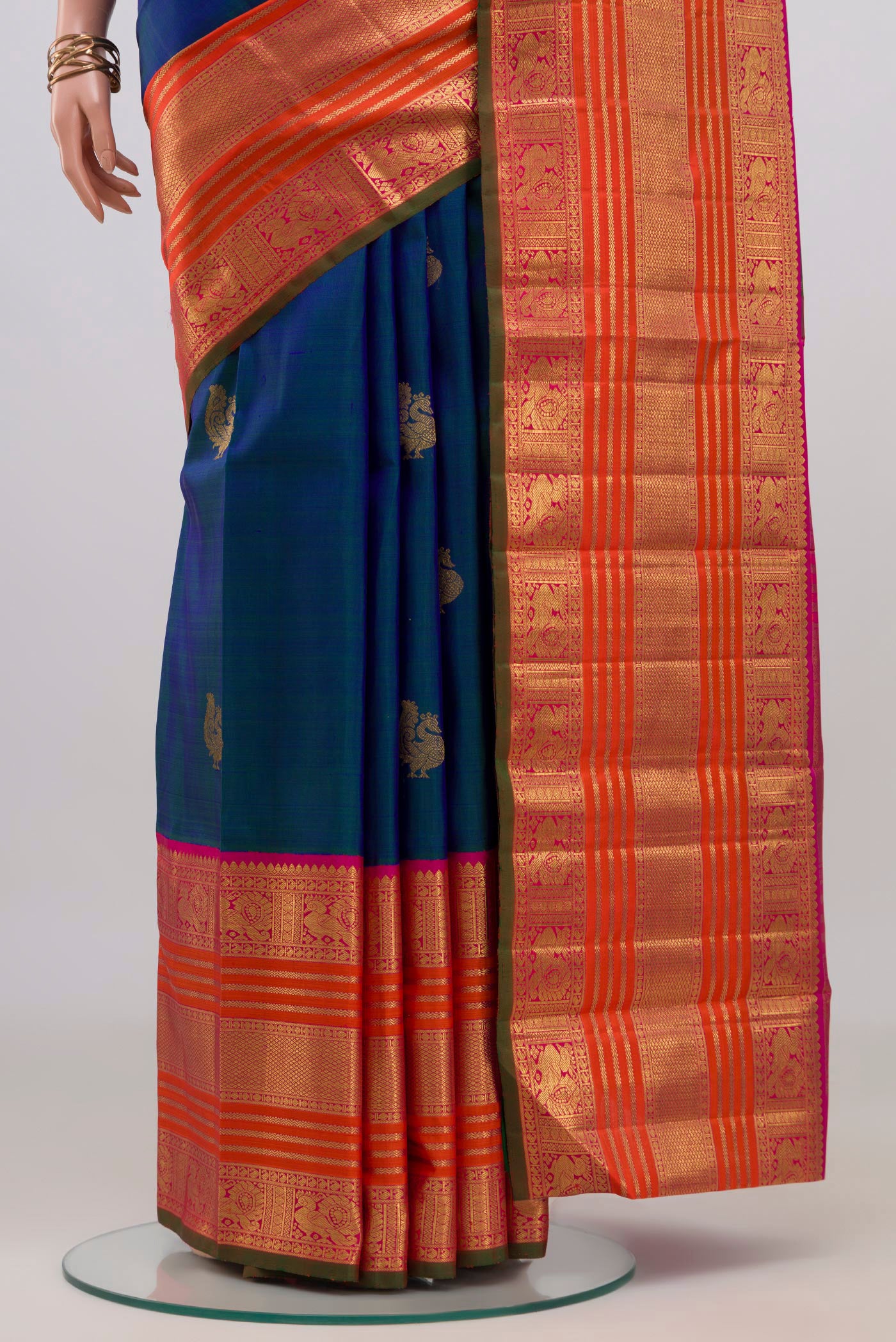 Pleats and pallu of Pure Silk Pure Zari Peacock Blue Kanchipuram Saree with Zari Butta on the body and Zari Border. 