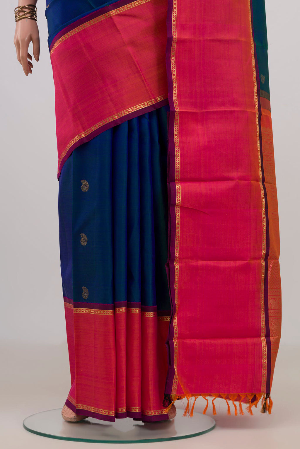 Pleats and pallu of Pure Silk Pure Zari Peacock Blue Kanjivaram Saree with Zari Butta on the body and Thin Zari Line. 
