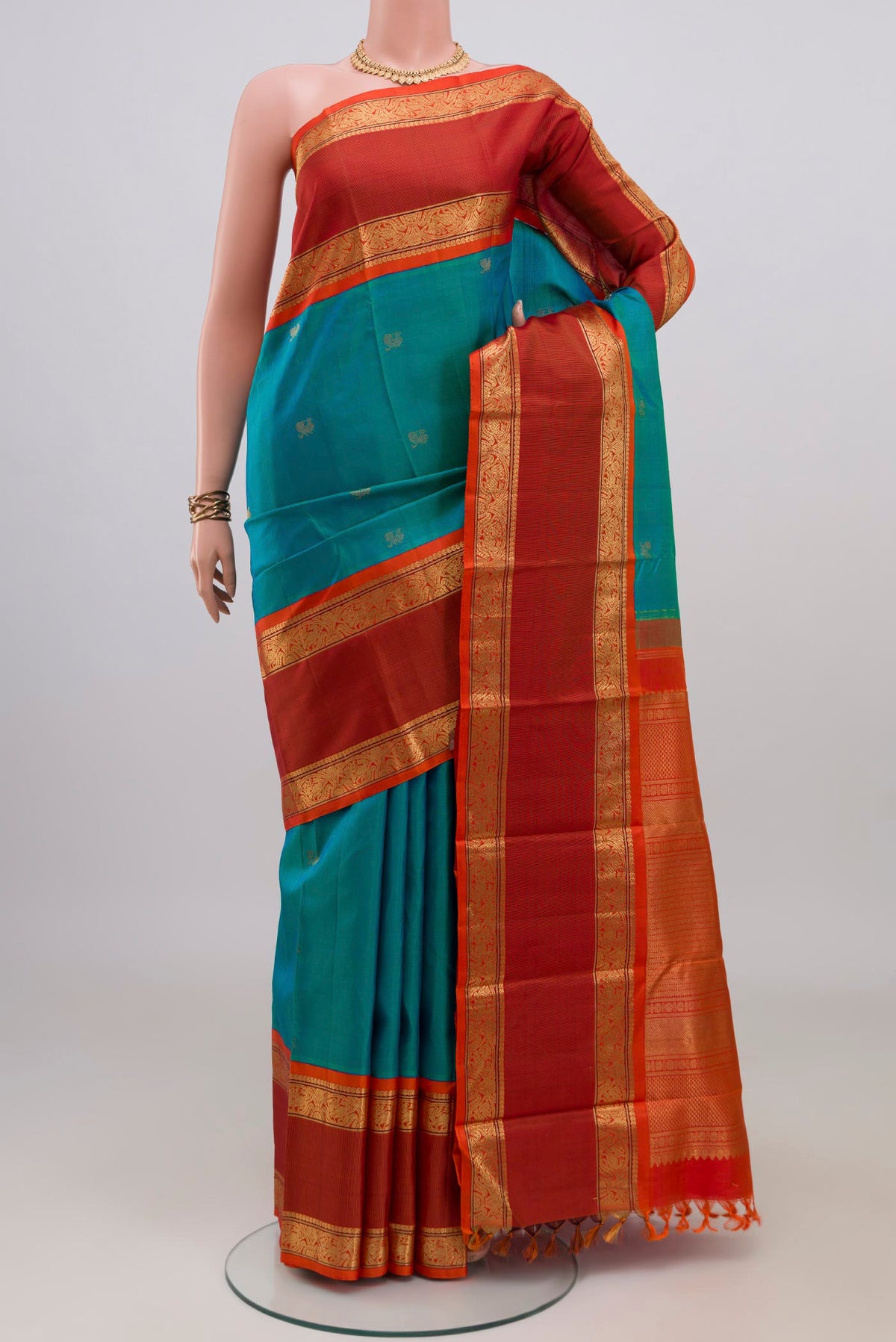 Pure Silk Pure Zari Blue Kanjivaram Saree with Zari Butta on the body and Zari Border.  displayed on a mannequin