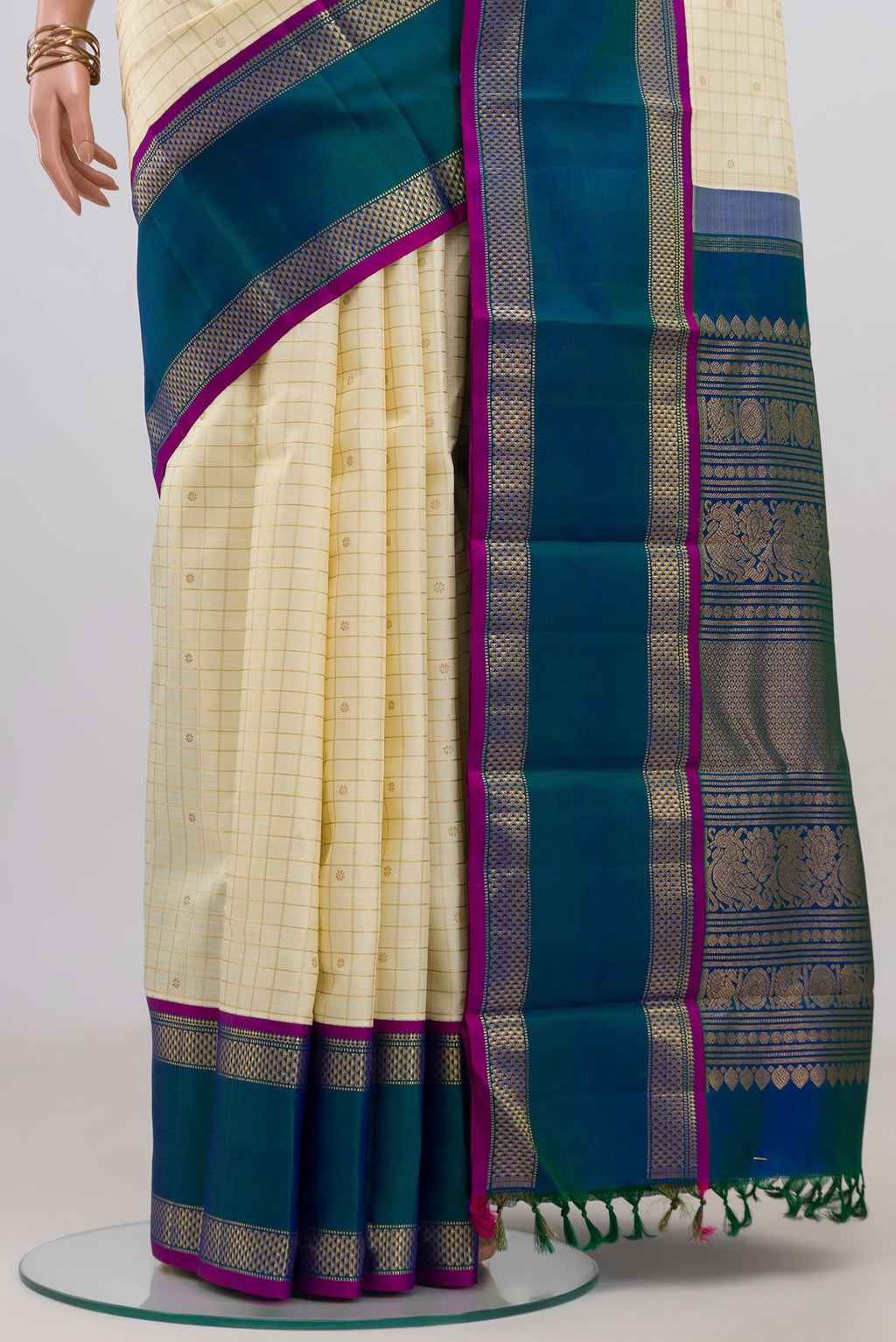 Pleats and pallu of Pure Silk Pure Zari Cream Kanjivaram Saree with Checked design on the body and Zari Border. 