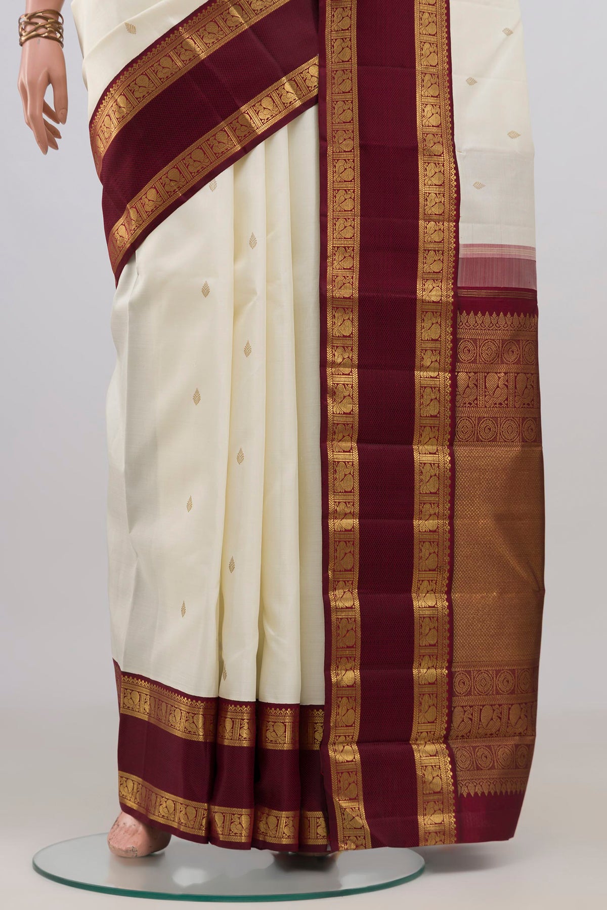 Pleats and pallu of Pure Silk Pure Zari Off White Kanjivaram Saree with Zari Butta on the body and Zari Border. 