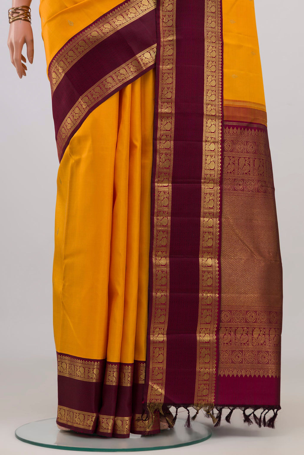Pleats and pallu of Pure Silk Pure Zari Yellow Kanjivaram Saree with Zari Butta on the body and Zari Border. 