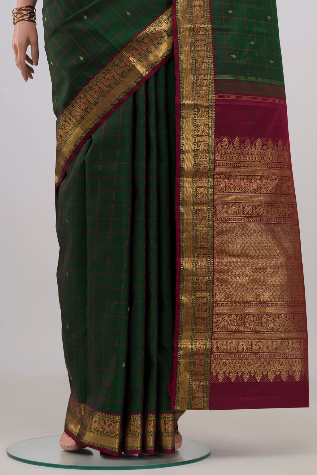 Pleats and pallu of Pure Silk Pure Zari Bottle Green Kanjivaram Saree with Checked design on the body and Zari Border. 