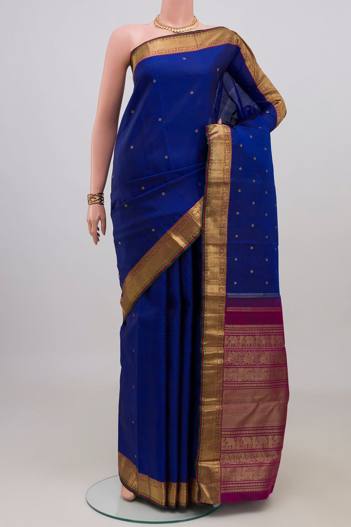Pure Silk Pure Zari Blue Kanjivaram Saree with Zari Butta on the body and Zari Border.  displayed on a mannequin