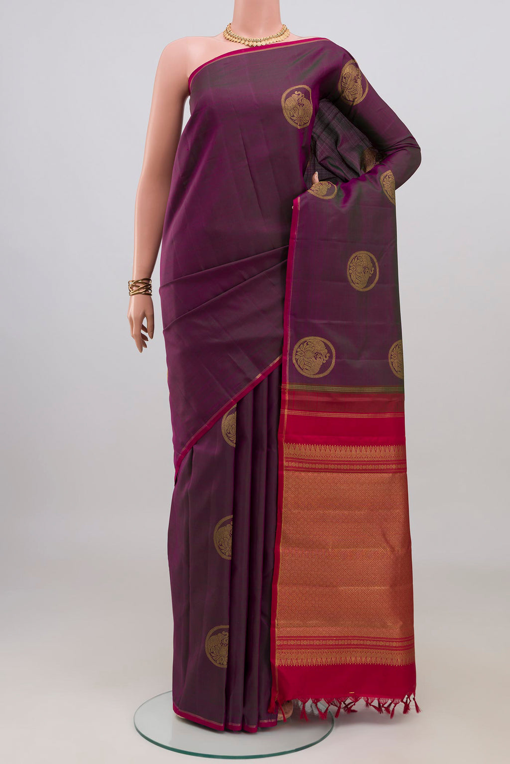 Pure Silk Pure Zari Purple Kanchipuram Saree with Zari Butta on the body and Thin Zari Line.  displayed on a mannequin