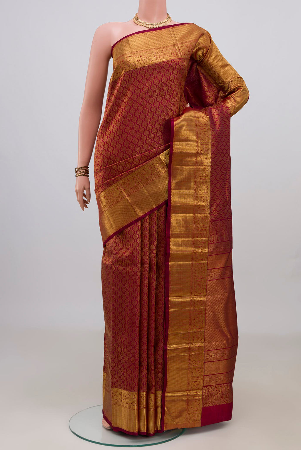 Pure Silk Maroon Kanchipuram Saree with Zari Brocade on the body and Zari Border.  displayed on a mannequin