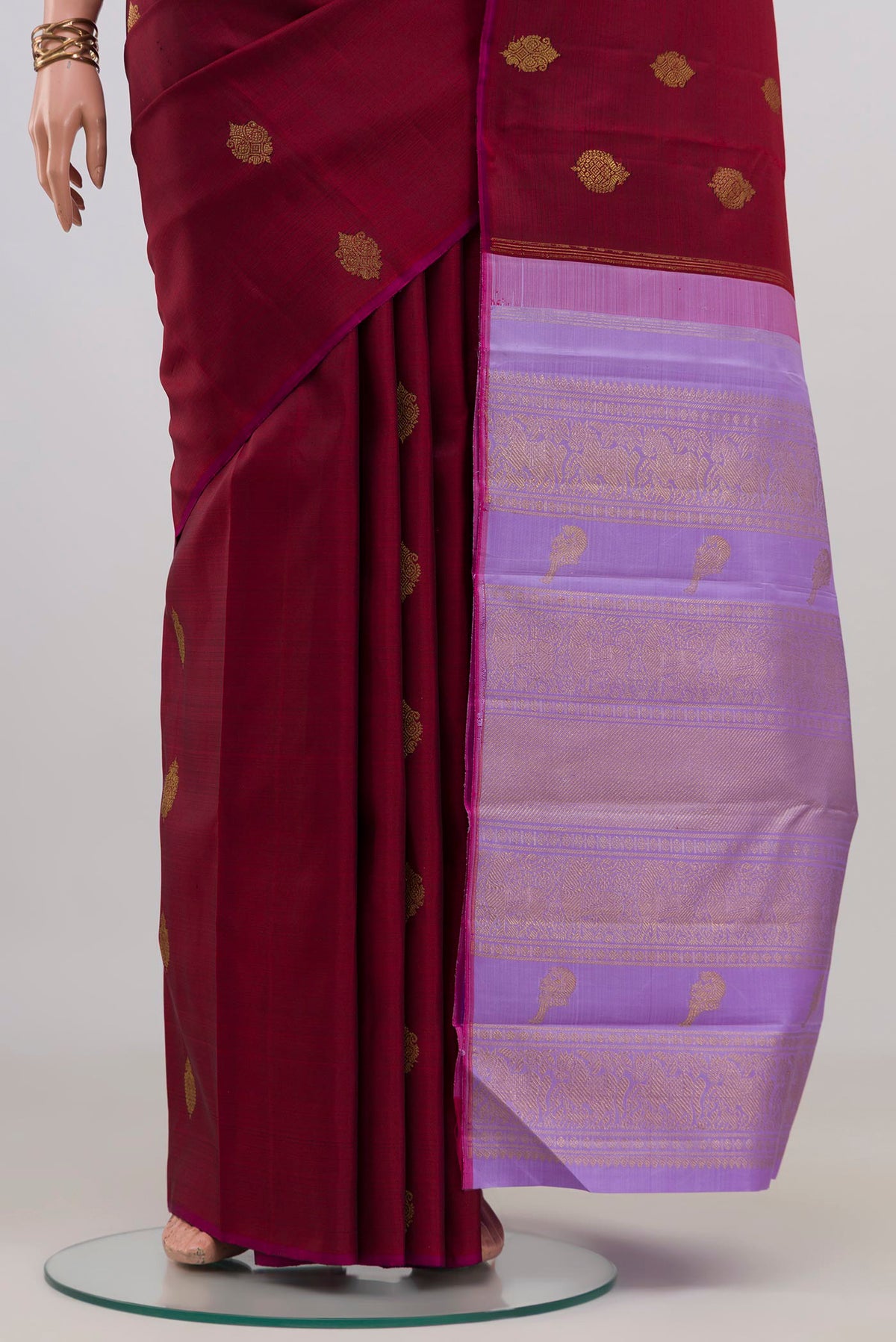 Pleats and pallu of Pure Silk Pure Zari Maroon Kanchipuram Saree with Zari Butta on the body and Without Border. 