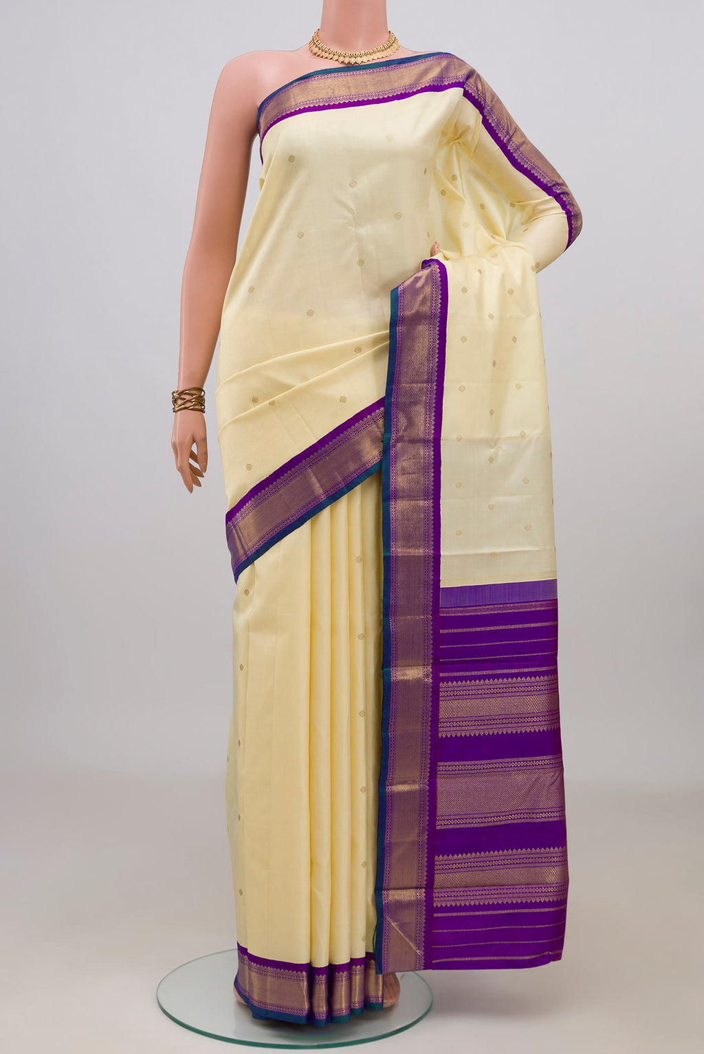 Pure Silk Pure Zari Cream Kanjivaram Saree with Zari Butta on the body and Zari Border.  displayed on a mannequin