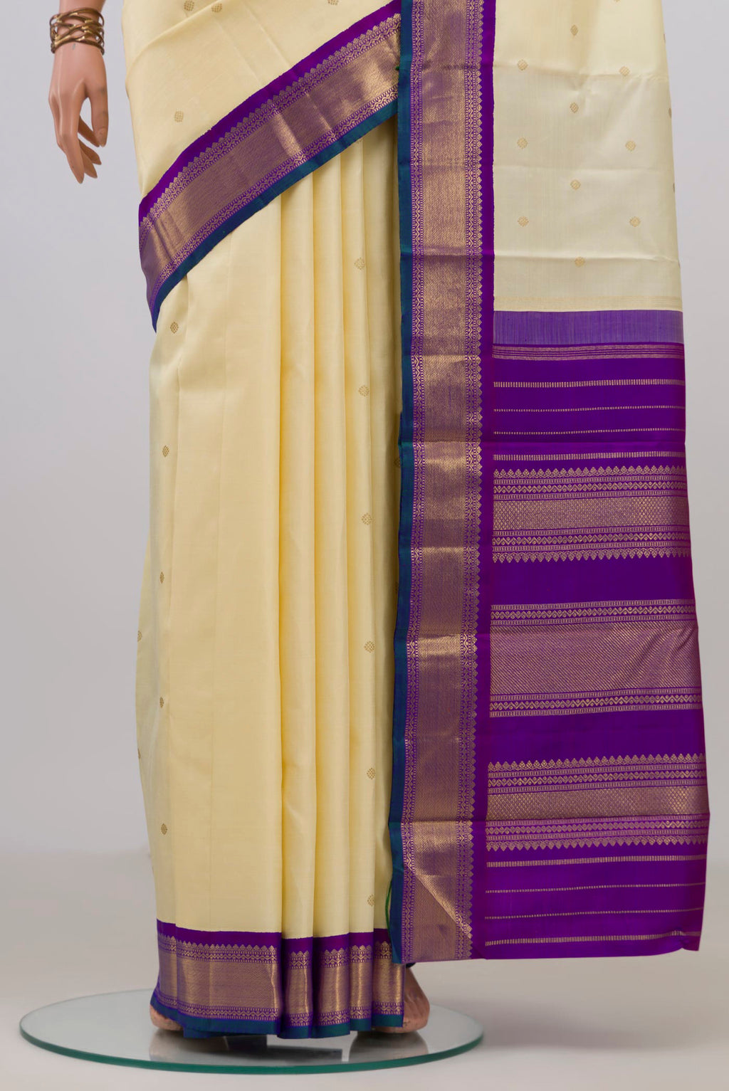Pleats and pallu of Pure Silk Pure Zari Cream Kanjivaram Saree with Zari Butta on the body and Zari Border. 