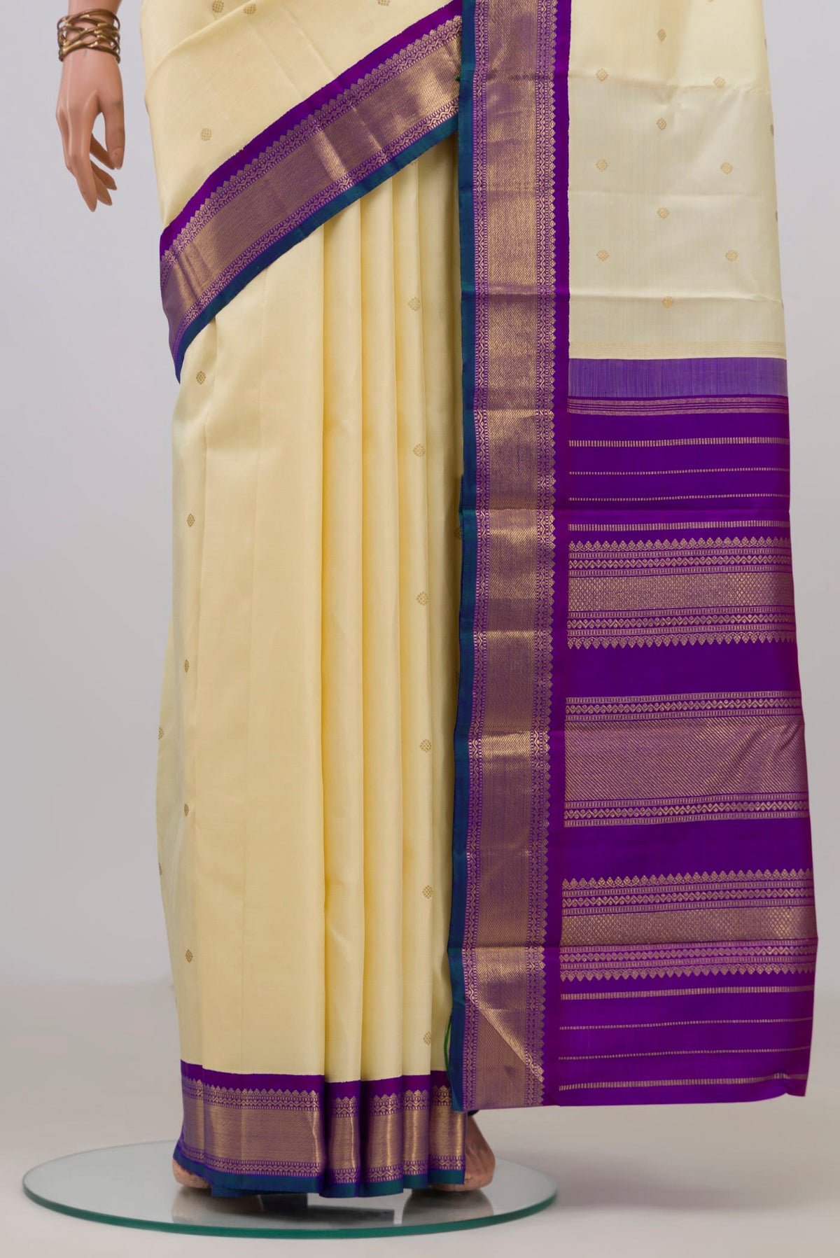Pleats and pallu of Pure Silk Pure Zari Cream Kanjivaram Saree with Zari Butta on the body and Zari Border. 